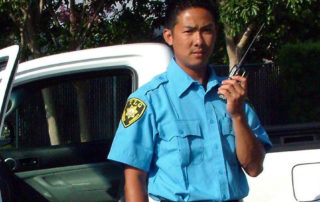 TLG Security Guard on Site with Patrol Unit on Radio